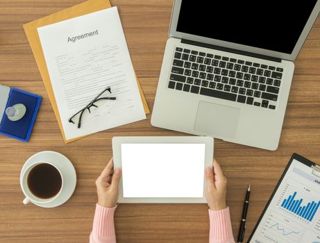 woman working at office desk and using taplet computer.  top view
