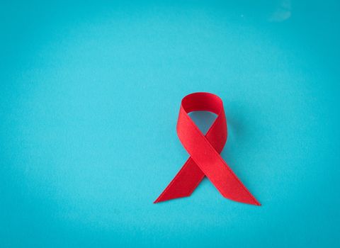 red ribbon on blue background. symbol world aids day.