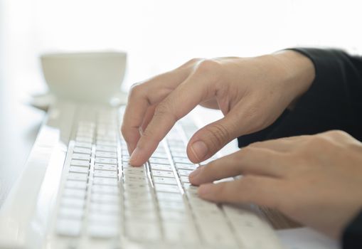 human's hands typing on computer keyboard. selective focus.