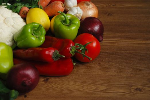 Healthy organic  Assortment of fresh vegetables on dark wooden table.