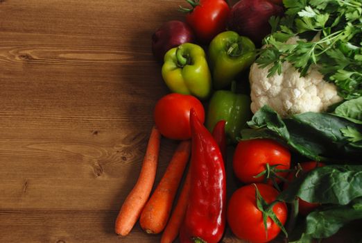 Healthy organic  Assortment of fresh vegetables on dark wooden table.