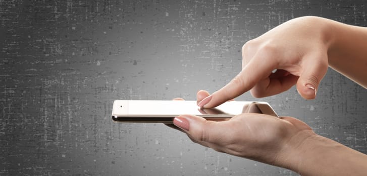 smartphone in a female hand on black background