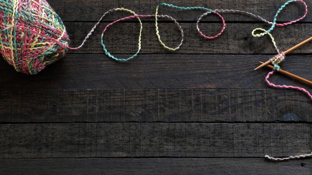 Knitted background with knitting needle and ball of yarn, knit is hobby, leisure activities of many people in free time, also make many handmade product