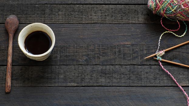 Knitted background with knitting needle, yarn and coffee cup, knit is hobby, leisure activities of many people in free time, also make many handmade product
