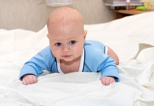 Indoor close up shot of boy lying on stomach