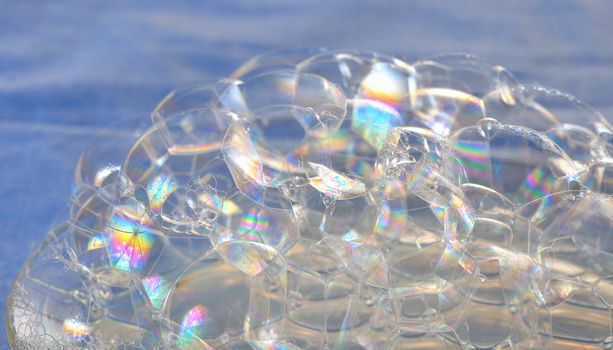 soap bubbles close up on blue background