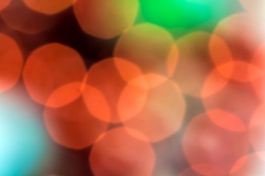 Festive blur - red and green round bokeh. Defocused image. Colorful backdrop for cards, posters, banners.