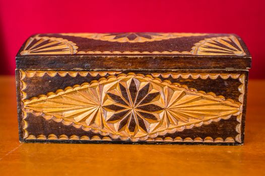 vintage wooden box on the table on a red background