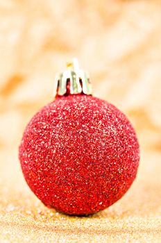 Red Christmas tree decorations on golden lights background