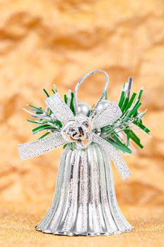 Silver bell decorate for christmas on gold background.