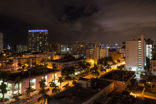 Long exposition night shot of Miami Beach, Florida, with Downtown Miami skyscrapers in the distance.