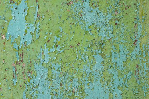 rusty iron surface covered with old chipped paint, which has long been influenced by different climatic conditions