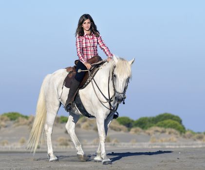 horsewoman and her horse on the beach