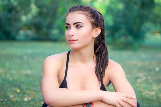 Young fitness girl rests during training workout outdoor