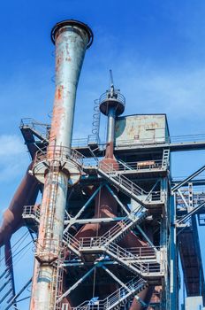 General view of an industrial plant refinery, consisting of pipes and towers of heavy industry.