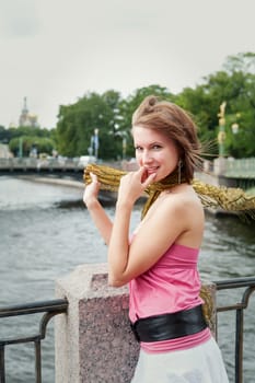 portrait of cheerful young woman near the river outdoor