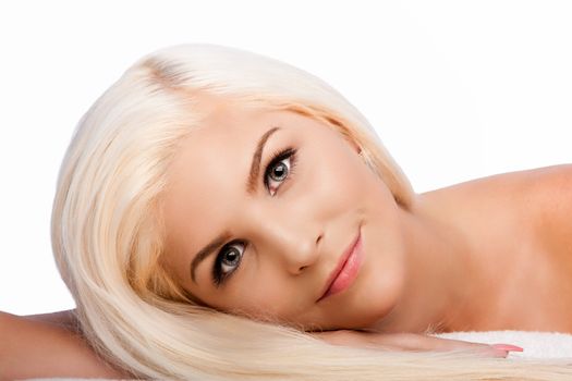 Beautiful face of young woman for Aesthetics facial skincare concept laying on side, on white.