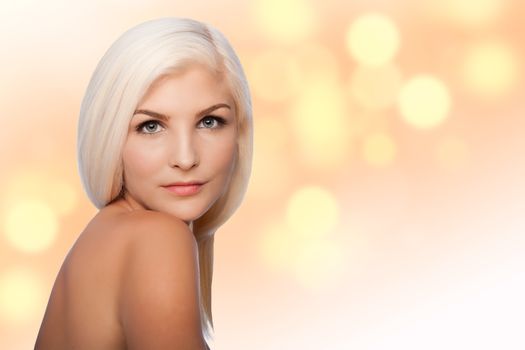 Beautiful face of young woman for Aesthetics facial skincare concept looking over shoulder, on blurred lights background.