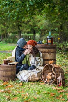 Romantic happy couple at fall in the autumn garden