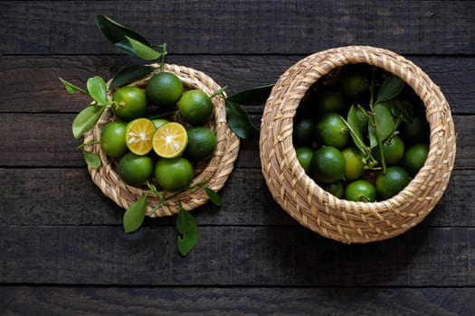 Green Kumquat fruit on wooden background, a popular agriculture product of Vietnam, rich vitamin c, healthy fruit