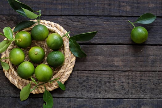 Green Kumquat fruit on wooden background, a popular agriculture product of Vietnam, rich vitamin c, healthy fruit