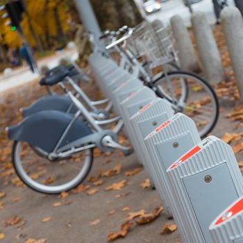 Station of urban bicycles for rent downtown. Green sustainable ecological public transport. Healthy lifestyle.