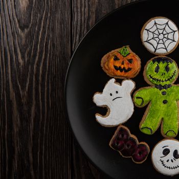 Homemade delicious ginger biscuits for Halloween on wooden table