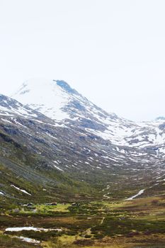 Beautiful spring Norway mountains with melting snow on tops