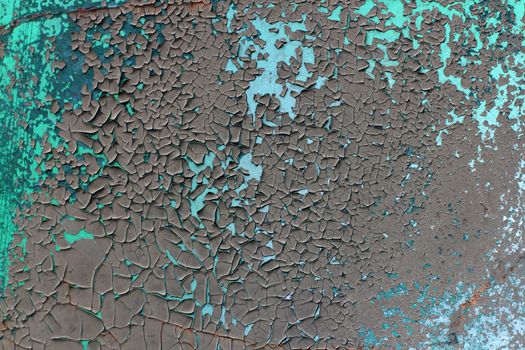 Tatter of a multi-colored old paint on a surface of a stone wall