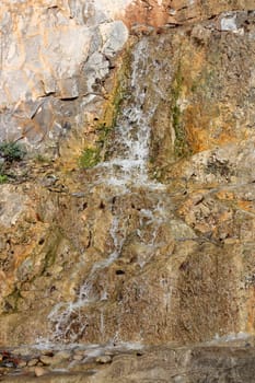 a small mountain brook running over stones closeup
