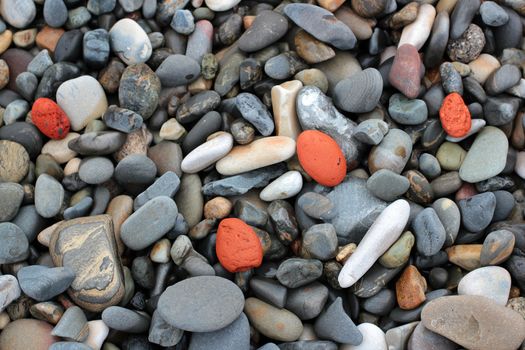 red stones on a pebble beach background