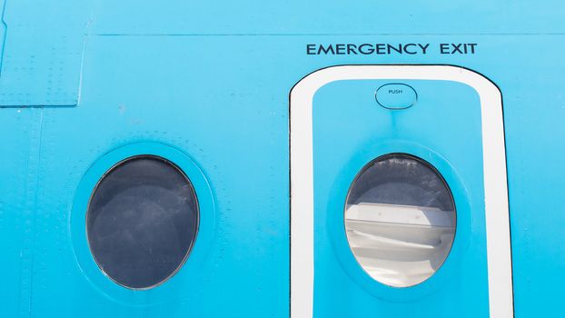 Windows of airplane with emergency exit door