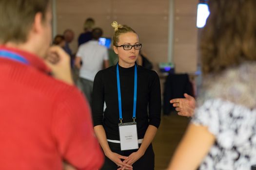 People interacting during coffee break at medical or scientific conference.