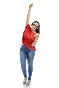 Happy woman listen music on her phone, isolated over white background 