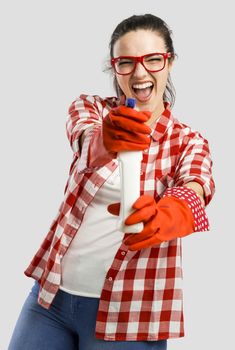 Pretty woman wearing gloves and holding a cleaning spray 