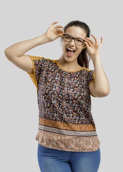 Portrait of a beautiful woman making a happy face, isolated over a white background 