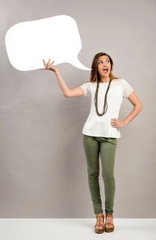 Beautiful woman holding a speech bubble