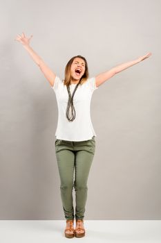 Beautiful young happy woman with arms up