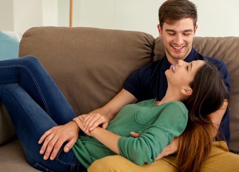 Young couple sitting on the sofa and dating