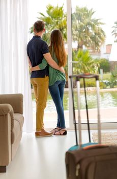 Young couple arriving the hotel for holidays