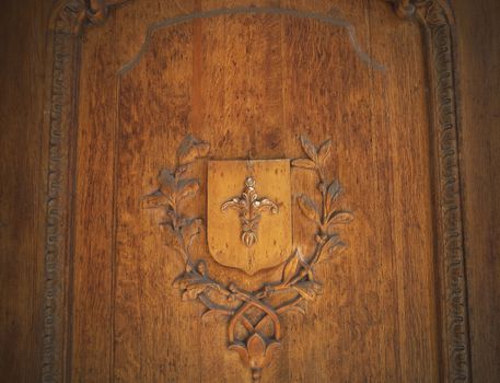 Wooden bas-relief on the door in the old style
