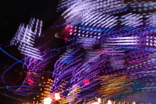 Night colors of the amusement park lights moving, light trails, slow shutter-speed