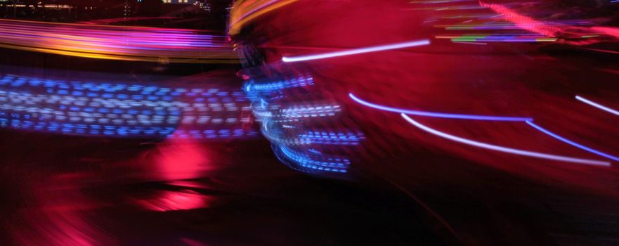 Night colors of the amusement park lights moving, light trails, slow shutter-speed