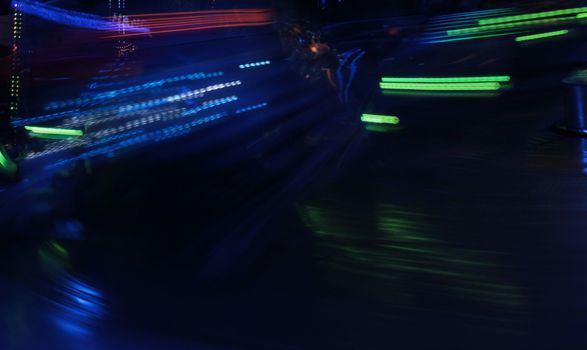 Night colors of the amusement park lights moving, light trails, slow shutter-speed