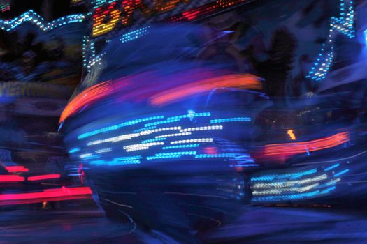 Night colors of the amusement park lights moving, light trails, slow shutter-speed