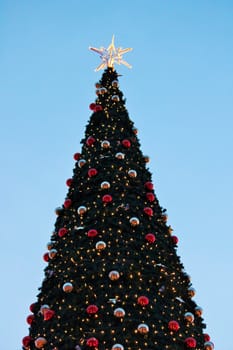 Christmas tree with star and baubles red and gold copy space