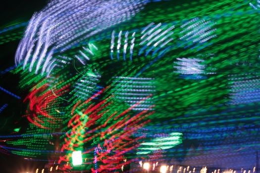 Night colors of the amusement park lights moving, light trails, slow shutter-speed