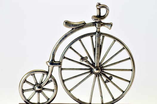 Ancestor of the bike in miniature on a white bottom.