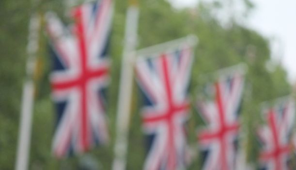 Many defocussed Union Jack flags background with copy space