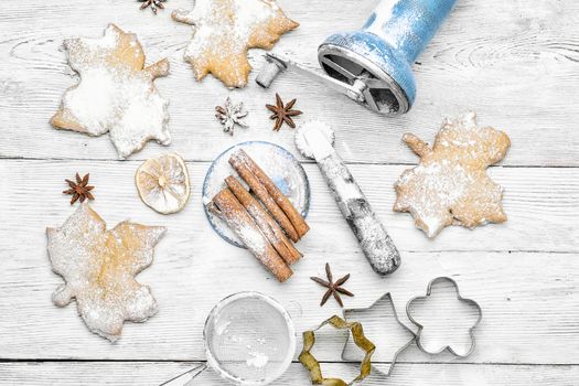 Homemade cookies in the shape of maple leaf on the kitchen table, for the winter holidays